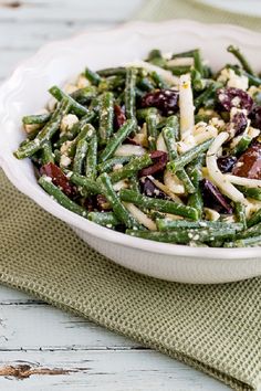 green bean salad with greek olives and feta cheese in a white serving bowl