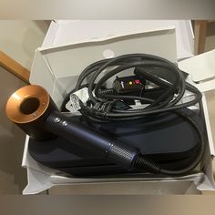 an open box containing a hair dryer and other items