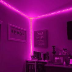 a room with purple lighting and pictures on the wall