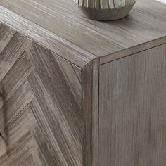 a bowl sitting on top of a wooden cabinet