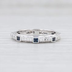 a white gold ring with blue and white diamonds