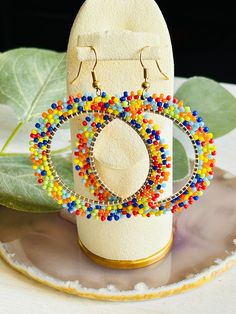 These adorable Seed Bead Hoop earrings are hand made in the USA.  Add a little bit of fun to your wardrobe ladies!  These earrings are the perfect accessory for a night out on the town or with a pair of your favorite jeans.  This earring is a great gift for any woman.  The earring is length 2 3/4" Colorful Beaded Circle Earrings As Gift, Colorful Beaded Circle Earrings For Gift, Circular Beaded Earrings With Tiny Beads For Gifts, Circular Beaded Earrings With Tiny Beads As Gift, Trendy Handmade Hoop Beaded Earrings, Circular Beaded Earrings As Gift, Small Hoop Earrings With Dangling Beads For Party, Trendy Hoop Beaded Earrings As Gift, Gift Hoop Beaded Earrings