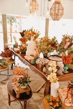 a table filled with cakes and flowers on top of it