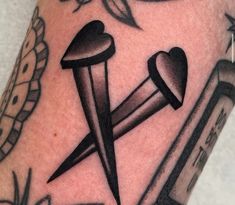 a tattoo with scissors and hearts on it