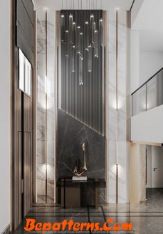 the entrance to an office building with marble floors and walls, along with chandeliers