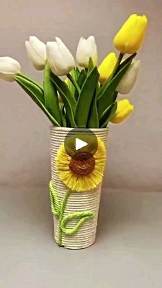 a vase filled with yellow and white flowers