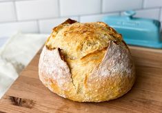 a loaf of bread sitting on top of a wooden cutting board