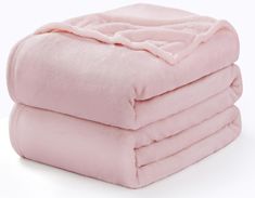 three pink blankets stacked on top of each other