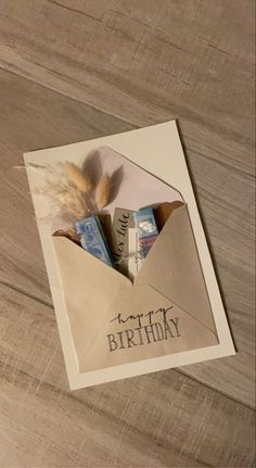 an open envelope with the words happy birthday written on it