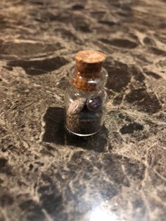 a bottle filled with sand sitting on top of a counter