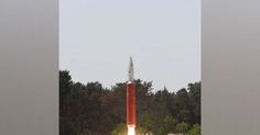 an image of a rocket launching into the sky with trees in the backgroud