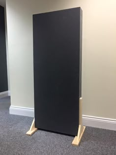 an empty room with two black speakers in it