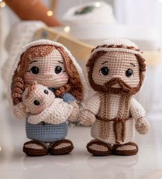 there is a crocheted nativity scene with jesus and baby jesus holding hands