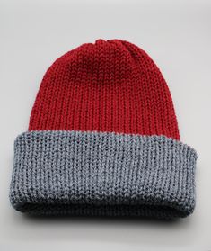 A beautiful handmade knitted hat in wine/red and black. It is double layered for extra warmth. Can be worn slouchy or as a beanie with folded brim. And best of all.... its reversible!! So you get to choose, do you want to wear it as a wine hat with grey brim, or grey hat with wine brim? The choice is yours!  This versatile hat is ideal for the cold Winter season! *Actual colours may vary slightly due to different device screen settings. Red Knitted Beanie For Winter, Red Knitted Winter Beanie, Red Knit Winter Hat, Red Winter Beanie One Size Fits Most, Red Winter Beanie, One Size Fits Most, Cozy Red Hat For Cold Weather, Red Knitted Hat For Fall, Red Knitted Hat For Cold Weather, Casual Red Yarn Beanie