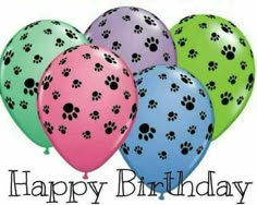 a bunch of balloons with paw prints on them and the words happy birthday written in black