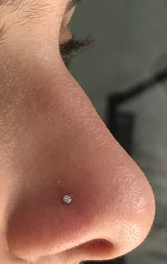 a close up of a nose with a small diamond in it's middle part