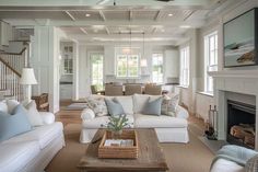 a living room filled with furniture and a fire place in the middle of a room