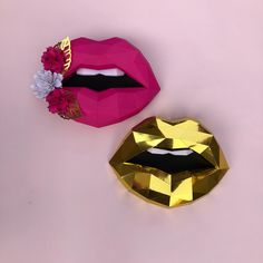 two pieces of paper that are shaped like lips and one has gold foil on it