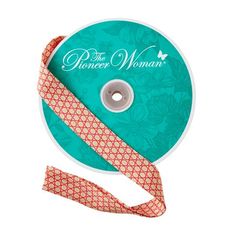 a reel of ribbon with the words, princess woman on it and an orange flower design