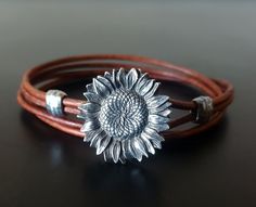 Womens Ankle Bracelet - Sunflower - Flower Leather Ankle Bracelet - Leather Anklet - Flower Jewelry - Womens Anklet - Sunflower Jewelry This Women Ankle Bracelet is bound to pop with this gorgeous Sunflower as a focal. It will feel like a summer is here no matter the time of year. As a leather Ankle bracelet, this beautiful sunflower jewelry is perfect. Better than a boutique of flowers, the women in your life will love this beautiful flower Jewelry.   We've added a 22 mm Sunflower to our 2 mm n Boutique Of Flowers, Leather Anklets, Womens Ankle Bracelets, Leather Bracelets Women, Womens Bracelet, Bracelet Flower, Sunflower Jewelry, Bracelet Leather, Wedding Jewelry Bracelets