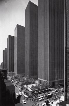 an old black and white photo of tall buildings