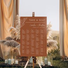 a table plan is set up on an easel in front of some drapes