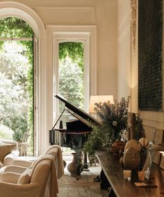 a living room filled with furniture and a grand piano