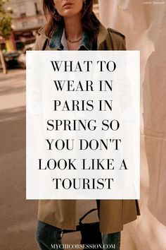 a woman standing in front of a white sign that says, what to wear in paris in spring so you don't look like a tourist