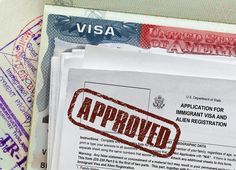 visa stamps are placed on top of some documents