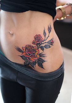 a woman with a rose tattoo on her stomach