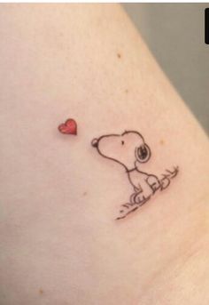 a small tattoo of a dog with a heart on it's side ribcage