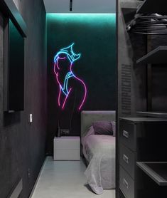 a room with a bed and neon lights on the wall, along with a night stand