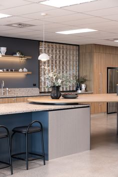 the kitchen is clean and ready to be used for cooking or eating, with two bar stools in front of the island