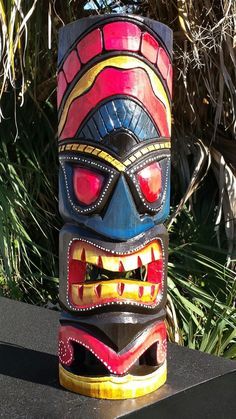 a colorful tiki mask sitting on top of a table