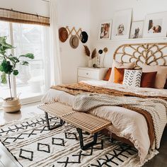 a large bed sitting in a bedroom on top of a wooden floor next to a window