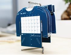 a desk calendar with clothes pins attached to it