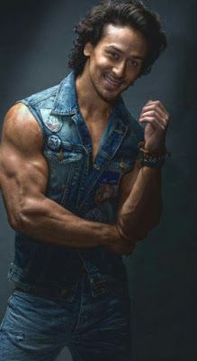 an image of a man in denims posing for a photo with his hands on his hips