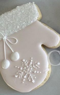 a cookie decorated with white icing and snowflakes