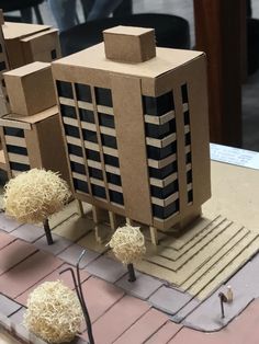 a model of a building made out of cardboard boxes and paper machs on a table