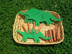 a basket filled with wooden sticks and paper cutouts in the shape of an alligator