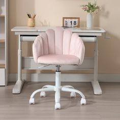 a pink chair sitting in front of a white desk