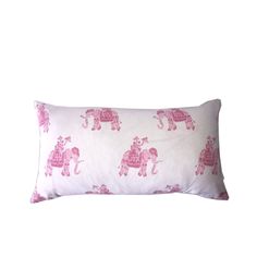 a pink and white pillow with an elephant print on the front, sitting against a white background