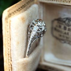 an antique diamond ring sits in a box