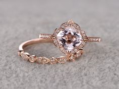 an engagement ring with a pink morganite surrounded by white and rose gold diamond accents