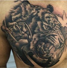 a man's chest with an image of two tigers on it and one tiger biting another