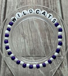 Show your team spirit with NCAA/Collegiate Bracelets! Each bracelet is individually handmade. Perfect gift for college sports fan, recent graduate or student. Colors are Purple & White. Bracelets are strung on jewelry elastic and come in several sizes that will fit most wrists. *Handmade item *Materials: beads, jewelry elastic, letter beads *Bracelet lengths available: 6", 6.5", 7", 7.5" & 8" Tips to care for your bracelets: *Always roll bracelets on rather than stretching *Avoid getting wet *Av Team Bracelets, College Game Day, Letter Bead Bracelets, College Game Days, Sports Bracelet, Bracelet Friendship, White Bracelets, College Sports, Letter Beads