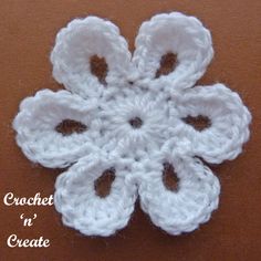 a crochet snowflake is shown on a brown surface with the words, crochet in create