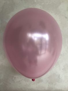 a pink balloon is hanging on the wall