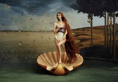 a woman with long hair standing on top of a large shell in front of a painting