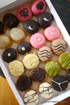 a box filled with lots of different flavored donuts